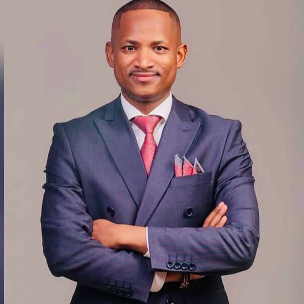 Babu Owino standing in a suit